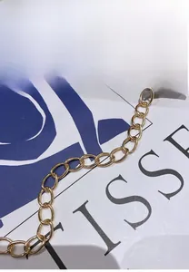 Detail of custom bright golden metal chain strap with flat oval links for crossbody bag