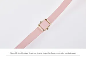 Detail of pink leather adjustable shoulder strap with gold buckle for crossbody bag