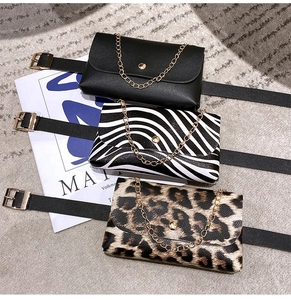 Detail of waist bags in black, zebra, and leopard patterns with gold chain and belt