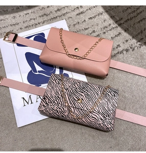Detail of pink and zebra print waist bags with gold chains and matching belts