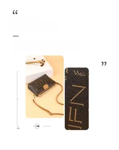 Detail showing high-quality textured leather with letter monogram and elegant crossbody strap