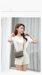 Outdoor model show of a rectangular mini crossbody bag with brown printed leather texture