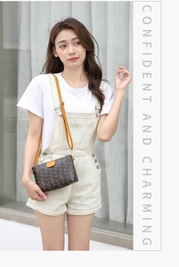 Detail of printed crossbody bag with yellow accents on a model wearing casual clothes