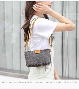 Side view of a contrast color crossbody phone bag worn by a model in casual outfit