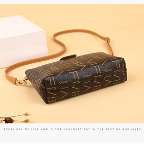 Detail of vintage monogram crossbody bag with leather strap and geometric props