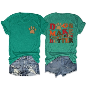Detail view of green T-shirt with 'DOGS MAKE EVERYTHING BETTER' slogan and denim shorts