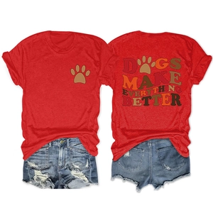 Flat lay of red T-shirt with 'DOGS MAKE EVERYTHING' print and ripped denim shorts