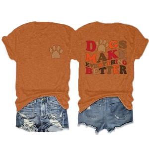 Flat lay of an orange t-shirt with Dogs Make Everything Better print and denim shorts