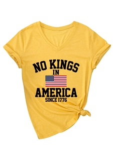 Detail of yellow V-neck T-shirt with No Kings in America print and stylish hem knot