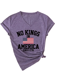 Detail of purple V-neck T-shirt with No Kings in America print and knotted hem