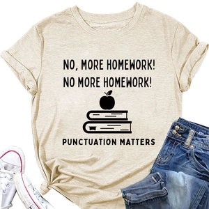 Close-up of beige T-shirt with 'No More Homework' slogan text and apple graphic detail