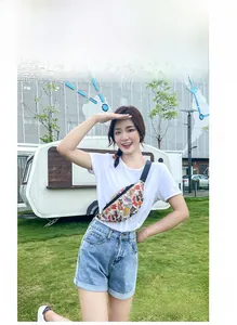 Outdoor lifestyle view of a colorful sneaker print waist bag worn as a crossbody pack