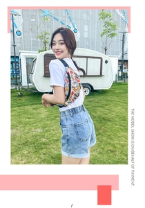 Outdoor lifestyle view of a colorful printed fanny pack with adjustable strap and cartoon art