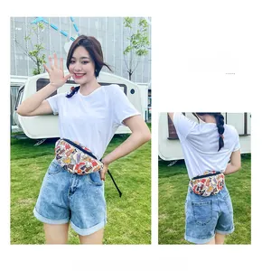 Detail of white canvas waist bag with colorful sneaker print and black zipper strap