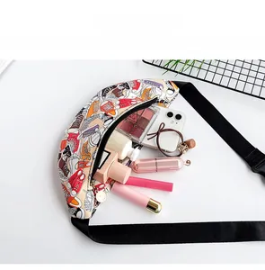 Detailed view of spacious interior of cream waist bag with colorful sneaker print