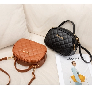 Detail of oval quilted handbags in black and brown featuring gold hardware and logo