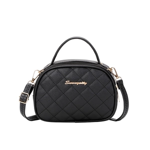 Quilted black oval handbag with gold hardware and top handle for women's shoulder wear