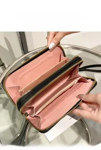 Detail of black double-zipper wallet featuring large capacity card slots and pink interior
