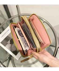 Internal view of pink and beige patchwork wallet with multiple card slots and phone pocket