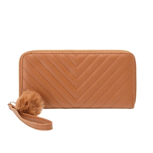 Brown long zippered wallet for women with V-shaped quilting and a fluffy pompom charm