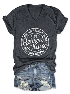 Close-up of Retired Nurse print on a dark grey V-neck T-shirt and denim shorts