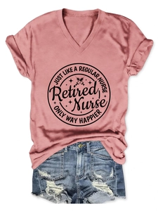 Detail of pink V-neck t-shirt with Retired Nurse print paired with denim shorts