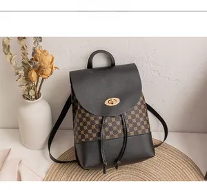 Detail of vintage patterned backpack with black pebble leather and golden oval twist lock