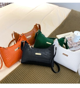 Detailed alligator texture on a variety of elegant vintage-style underarm shoulder bags
