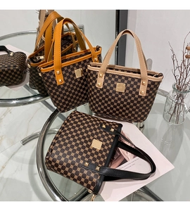 Close-up of printed bucket bags with metal rivets and golden square branding logo