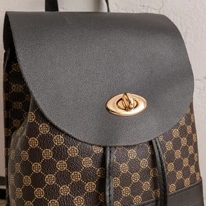 Brown monogram backpack with black leather flap and gold turn-lock closure