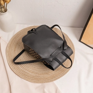 Black and brown patterned mini backpack with drawstring closure and PU leather detailing
