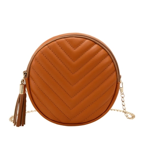 Caramel brown quilted round crossbody bag with fringe tassel and gold chain strap