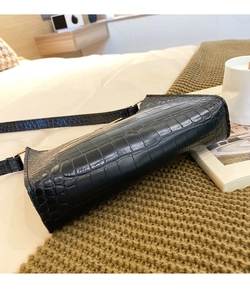Detailed view of black crocodile pattern faux leather shoulder bag with gold hardware