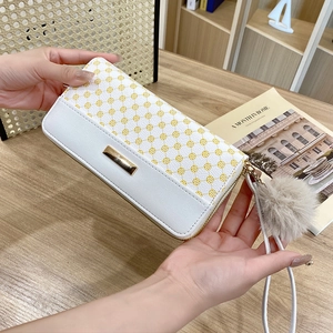 Women long printed wallet in white and yellow geometric patterns with fluffy pompom