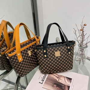 Retro printed bucket tote bags with metal studs and top handles in brown and yellow
