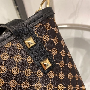 Vintage bucket bag with gold floral print and pyramid rivets on dark brown leather