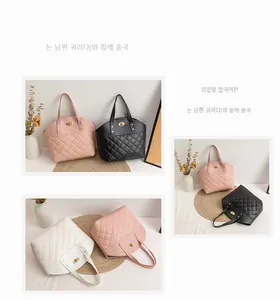 Detailed view of quilted PU leather handbag featuring a gold turn-lock clasp and dual handles
