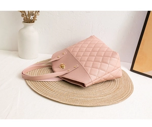 Detail of pink quilted leather handbag with gold twist lock and diamond stitching
