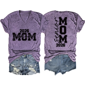 Detail of purple Senior Mom 2026 t-shirt with textured fabric and denim shorts