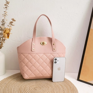 Pink quilted leather handbag with gold twist lock and handle studs for daily commuting
