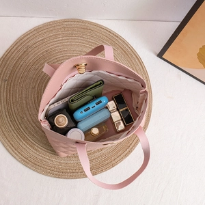 Pink quilted tote bag with gold twist lock showing spacious interior for daily essentials