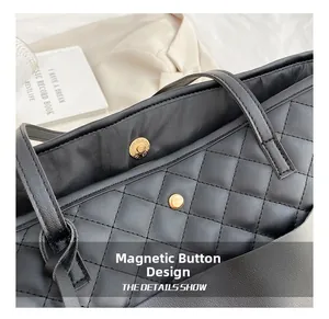 Detail of high-quality magnetic closure on black quilted leather tote bag for women