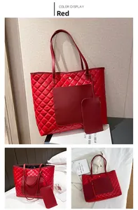 Detailed view of a red quilted tote bag with a matching small coin purse and long straps