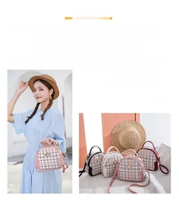 Detailed view of plaid round crossbody bag with golden bee buckle and thin shoulder strap