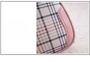 Macro view of plaid pattern bag with pink leather contrast piping and stitching