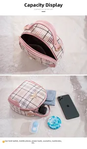 Detail view showing internal capacity of the plaid bee small bag for phones and cosmetics
