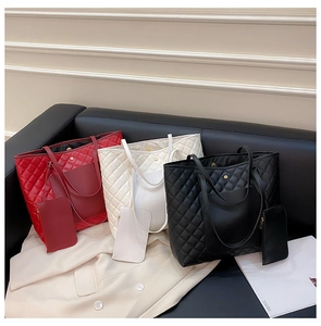 Detailed set of quilted tote bags in red, white, and black with matching mini pouches