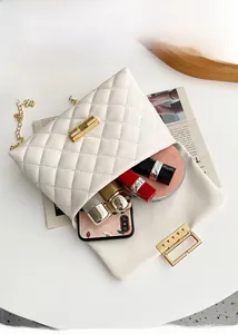 Internal view showing storage capacity for phone and makeup in quilted chain crossbody bag
