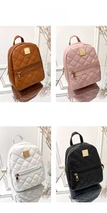 Four mini quilted backpacks in brown, pink, white, and black with gold metal hardware details