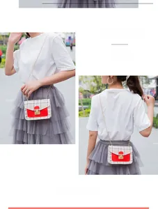 Detailed view of women's plaid crossbody bag with red flap and gold chain strap
